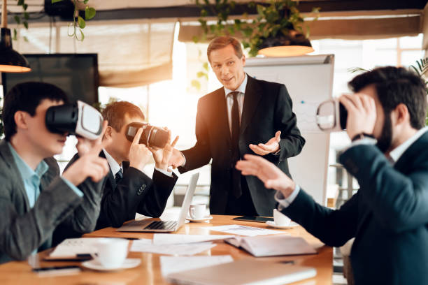 Meeting with chinese businessmen in office. Men are using virtual reality. stock photo