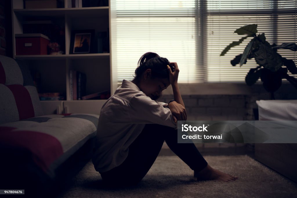 Business woman is depressed. She felt stressed and alone in the house. Depression - Sadness Stock Photo