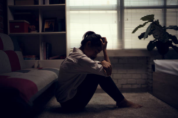 Business woman is depressed. She felt stressed and alone in the house. Business woman is depressed. She felt stressed and alone in the house. depression land feature stock pictures, royalty-free photos & images