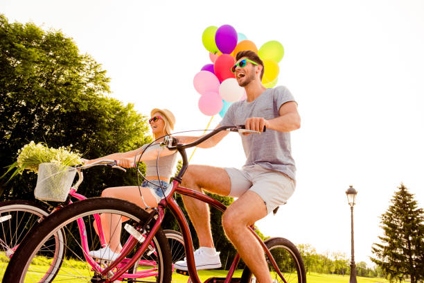 a senior lady pulls a wheelie on a box bike on a white background