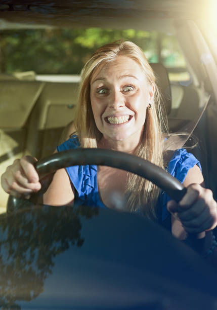 istock Stressed young woman driver grits her teeth 947812214