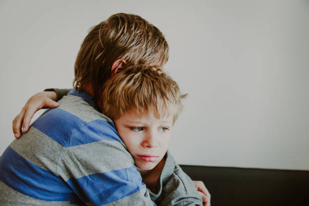 istock Father comforting sad child, parenting, sorrow 947812318
