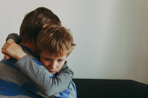 istock Father comforting sad child, parenting, sorrow 947812376