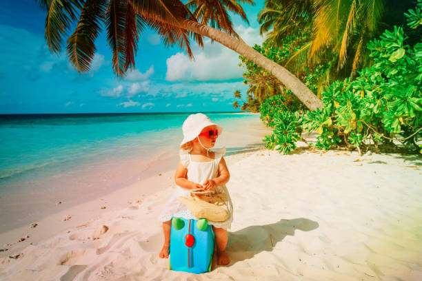 istock cute little girl travel on summer beach 947814708