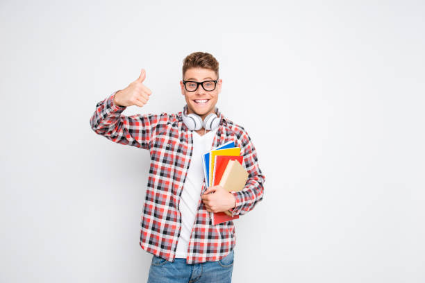 istock Young happy student showing thumb up on white background 947814750
