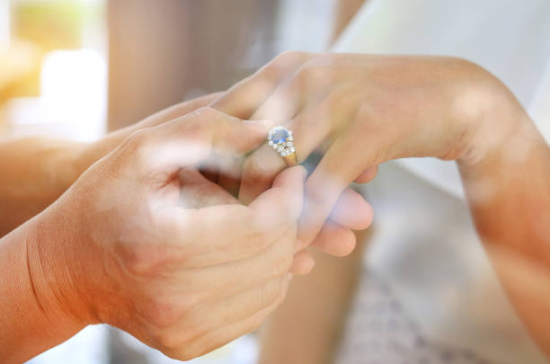 istock Reflection from window glass of Bride and groom with wedding rings. 947816886