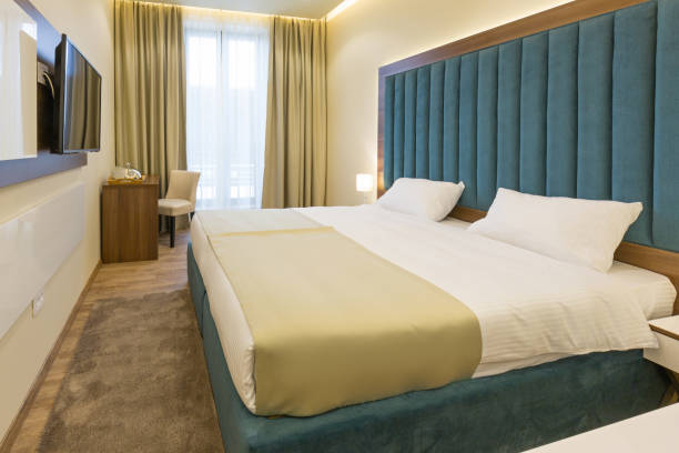 istock Interior of a double bed hotel bedroom 947827014