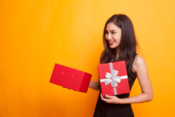 istock Young Asian woman open a gift box. 947833466