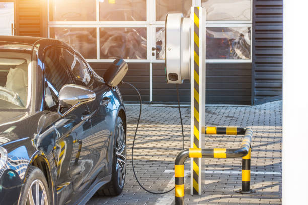 istock Refueling for electric cars e-mobility. Charging the machine, compartment door is open, the electric plug under voltage restores the battery charge. 947838514