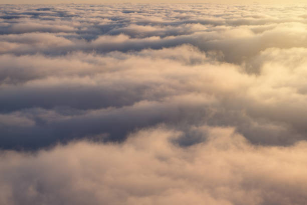 istock over clouds, view from above, sunlight, clouds close, flight by airplane 947838636