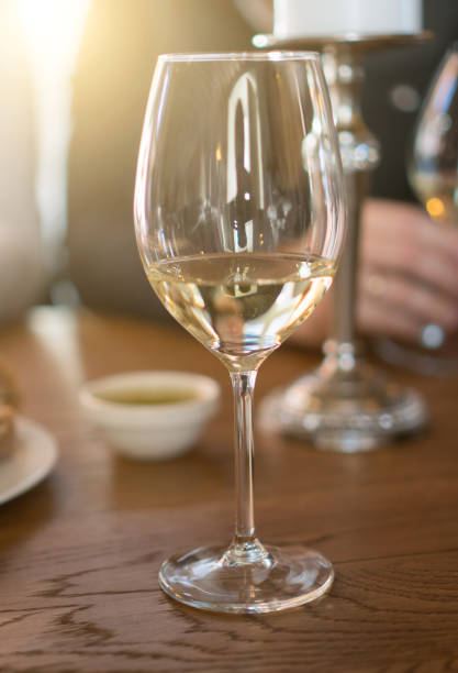 istock Glass of white wine is on the table. Wine degustation. 947843254