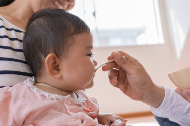istock Baby eating baby food 947843788