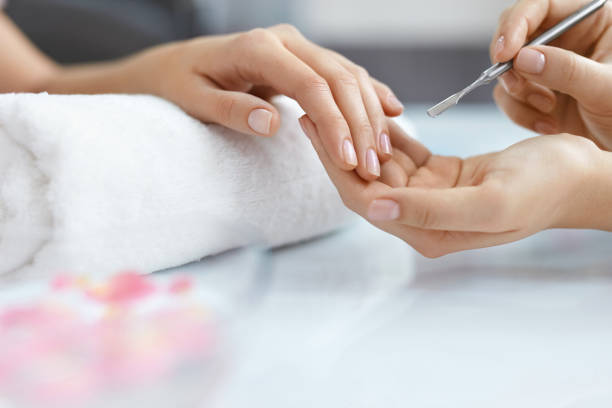 istock Nail Care. Female Hands Getting Manicure Procedure At Salon 947843926