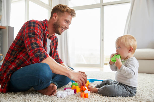 istock Young father and son playing together at home, close up 947844436