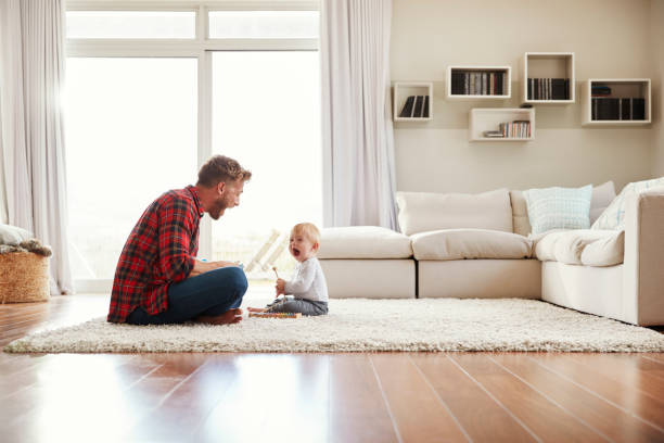 istock Young father and son playing together in their sitting room 947844630
