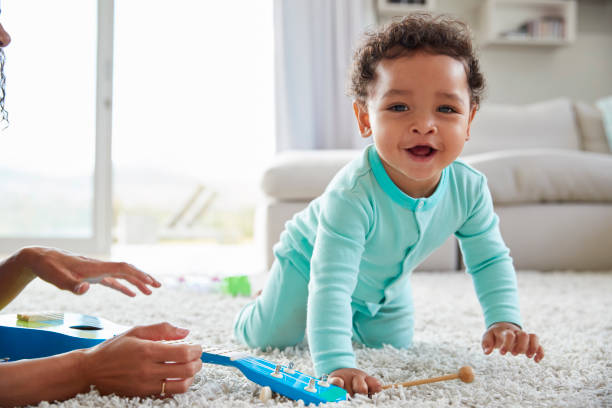 hijo de madre y el niño de raza mixta, jugando en casa, cerrar - onesie fotografías e imágenes de stock