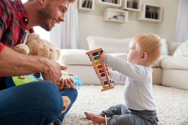 istock Dad and toddler son play with instruments at home, close up 947844802