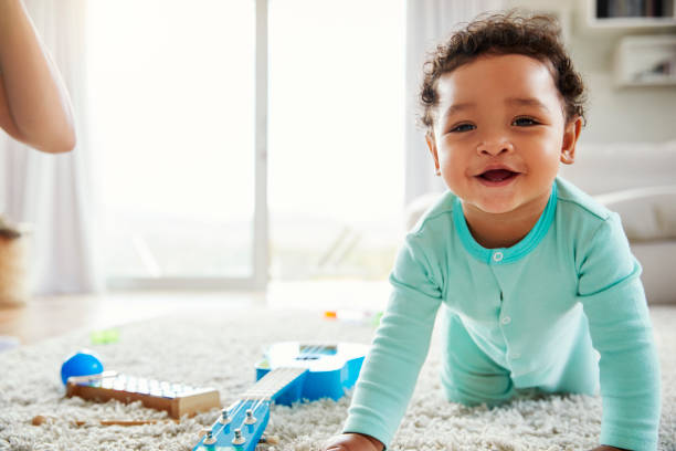 istock Happy mixed race toddler boy crawling in sitting room 947844904