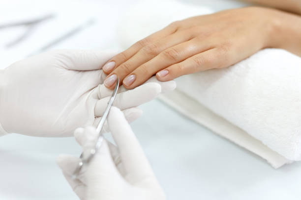 istock Nail Care. Female Hands Cutting Cuticles With Scissors. Manicure 947845552