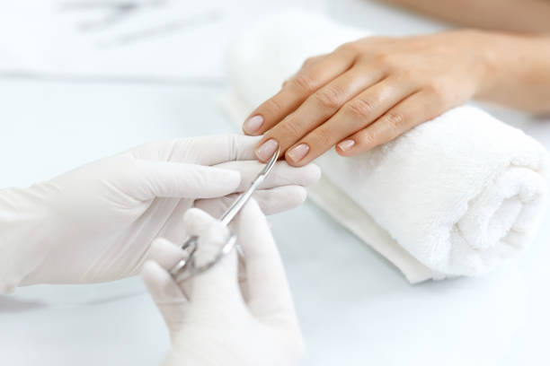 istock Nail Care. Female Hands Cutting Cuticles With Scissors. Manicure 947845650