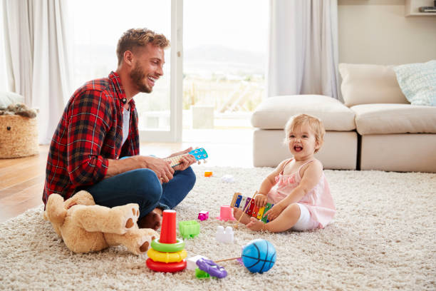 istock Father and young daughter playing toy instruments at home 947849050