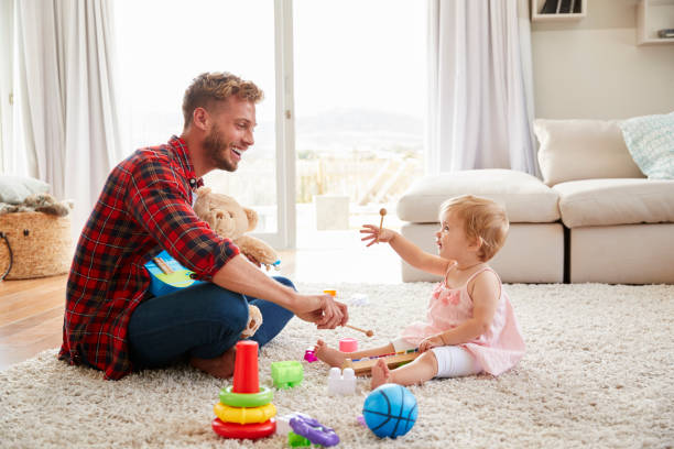 istock Father and young daughter playing toy instruments at home 947849094