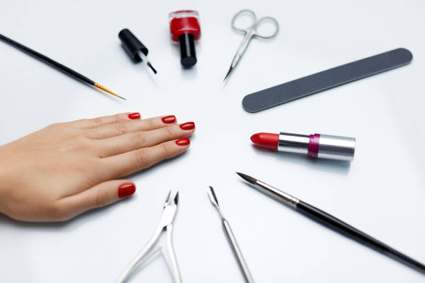 istock Manicure. Beautiful Woman Hand With Red Nail Polish And Tools 947853732