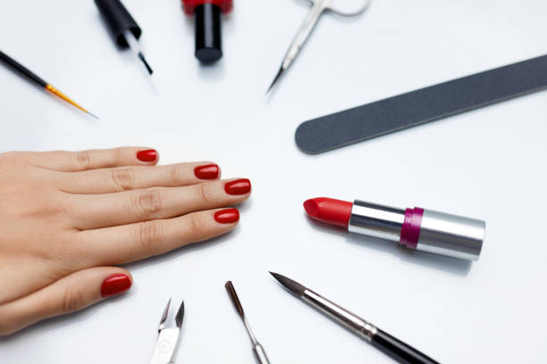 istock Manicure. Beautiful Woman Hand With Red Nail Polish And Tools 947853766