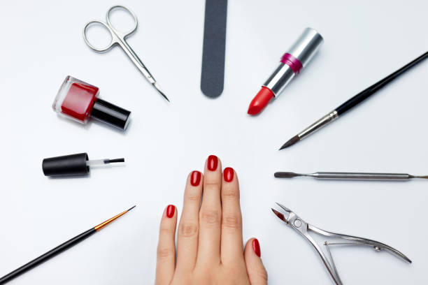 istock Manicure. Beautiful Woman Hand With Red Nail Polish And Tools 947853820