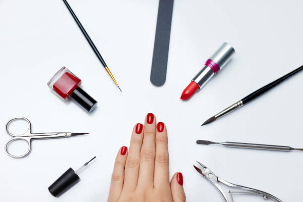 istock Manicure. Beautiful Woman Hand With Red Nail Polish And Tools 947853856