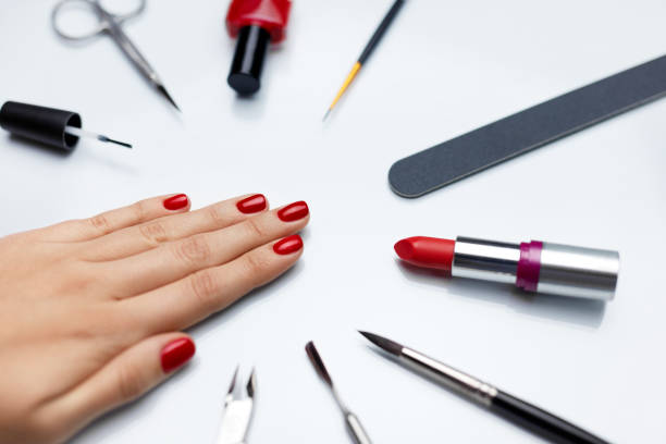 istock Manicure. Beautiful Woman Hand With Red Nail Polish And Tools 947853886