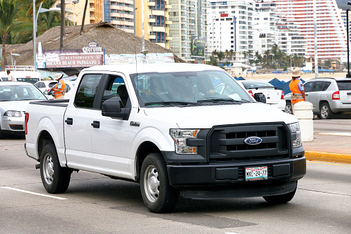Acapulco, Mexico - May 30, 2017: White pickup truck Ford F-150 in the city street.