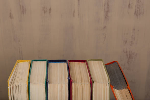 istock Back to school and education concept - colorful hardback books on brown background 947857892