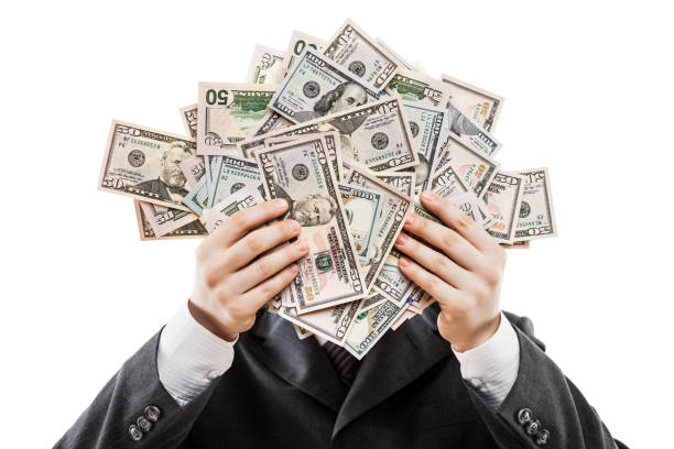 Businessman in black suit hand holding US dollar currency money stock photo