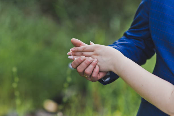 istock Dance pose of hands on the background of greenery 650. 947868618