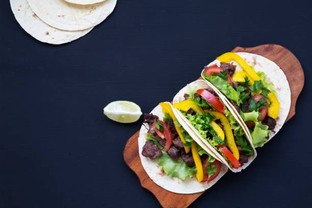 istock Beef tacos. Corn tortillas on dark background. Top view. Copy space. 947874292