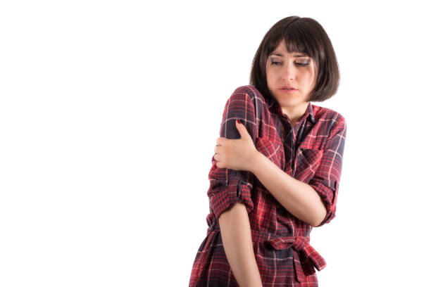 istock Woman Holding Her Shoulder in an Uneasy Manner 947886418