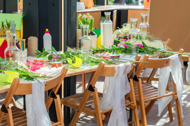 istock spring decoration workshop. Making flower bouquets and arrangements 947887006