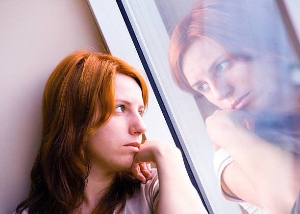 istock Red hair woman with window reflection 94789223