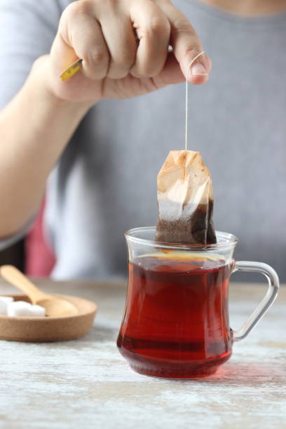 istock Dipping tea bag into a glass 947903330