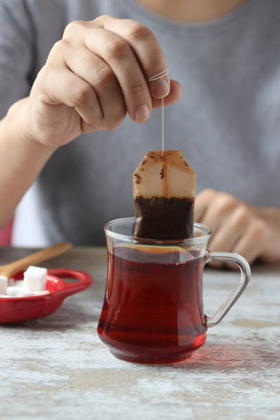 istock Dipping tea bag into a glass 947905628