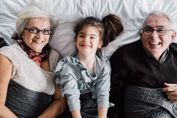 istock Grandparents sharing bed with granddaughter 947906294