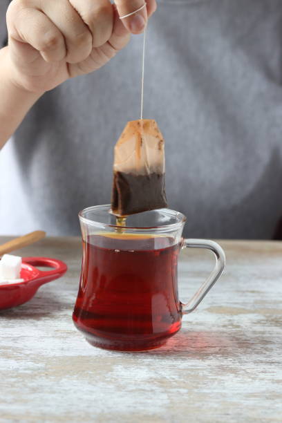 istock Dipping tea bag into a glass 947906996
