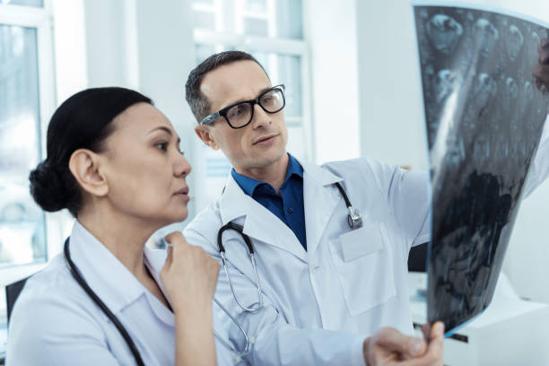 istock Serious doctors analysing a mri scan 947907898