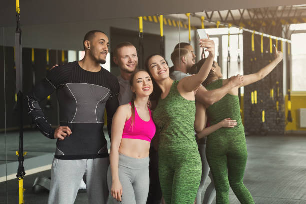 istock Young multiethnic group making selfie at gym 947917756