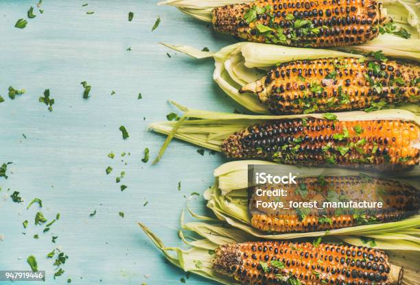 Grilled Sweet Corn With Cilantro Over Blue Background Copy Space Stock Photo - Download Image Now