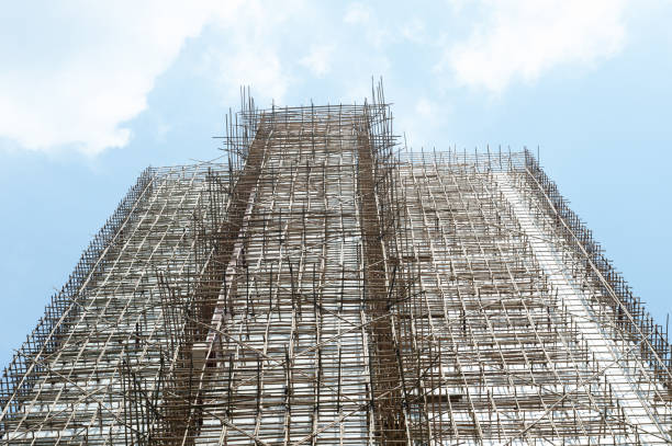 istock thousands of bamboo which is the Scaffolding project in office building construction site in hong kong downtown 947920228