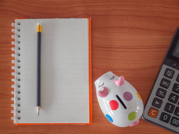 istock Top view , goals list with notebook , Piggy Bank , calculator. 947920398