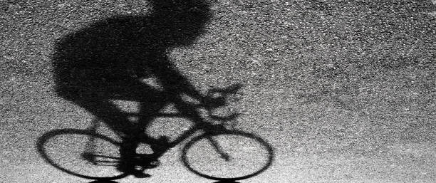 istock Blurry silhouette and shadow of a professional cyclist 947926836