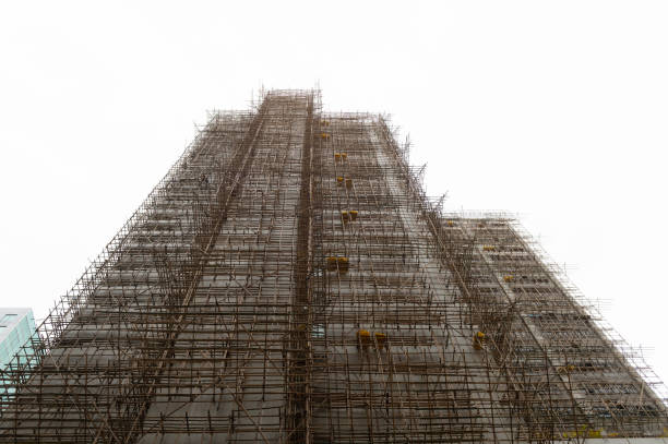 istock thousands of bamboo which is the Scaffolding project in office building construction site in hong kong downtown 947927770